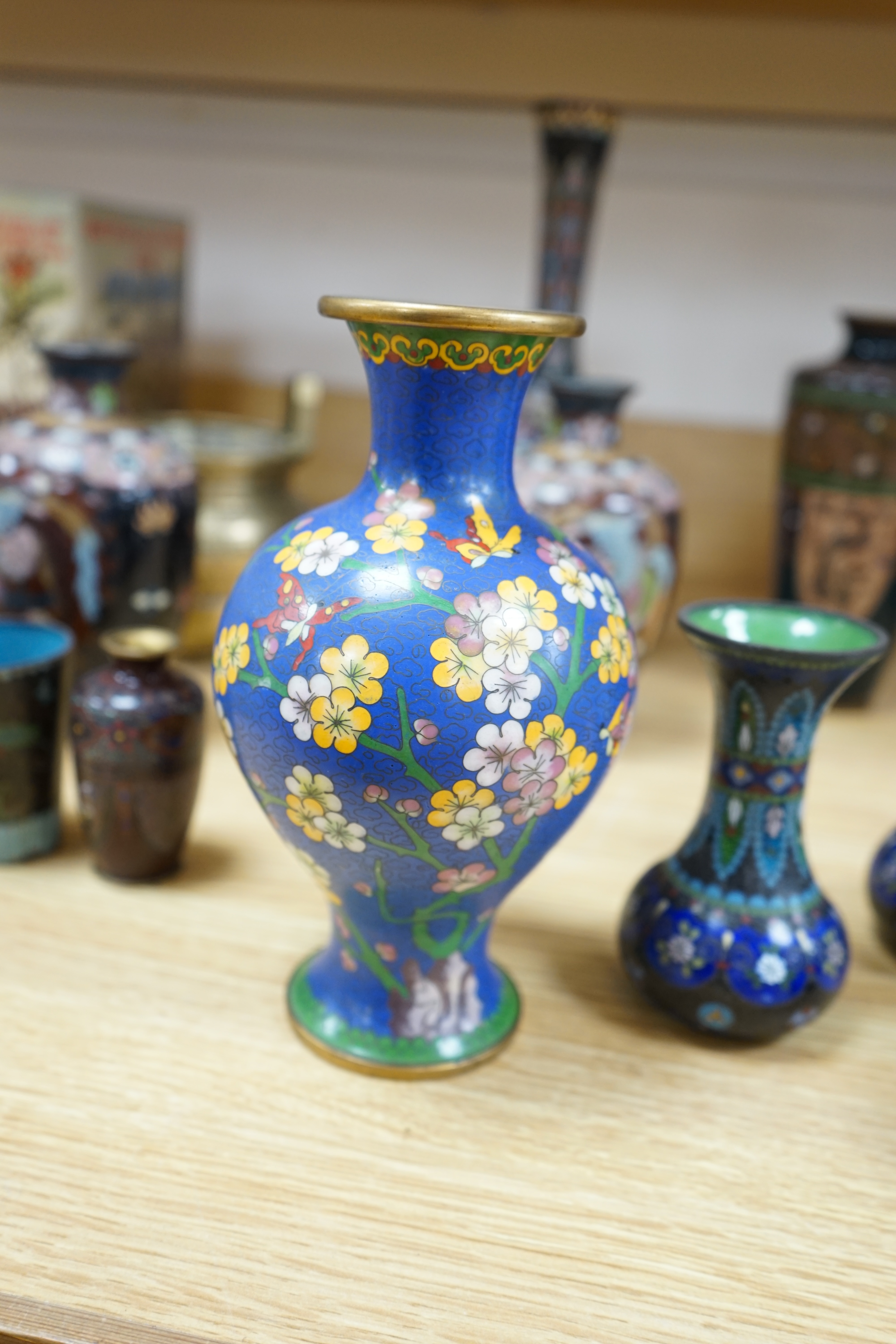 A large collection of Chinese and Japanese cloisonné vases and a brass twin handled censer, largest 31cm high. Condition - mostly poor to fair